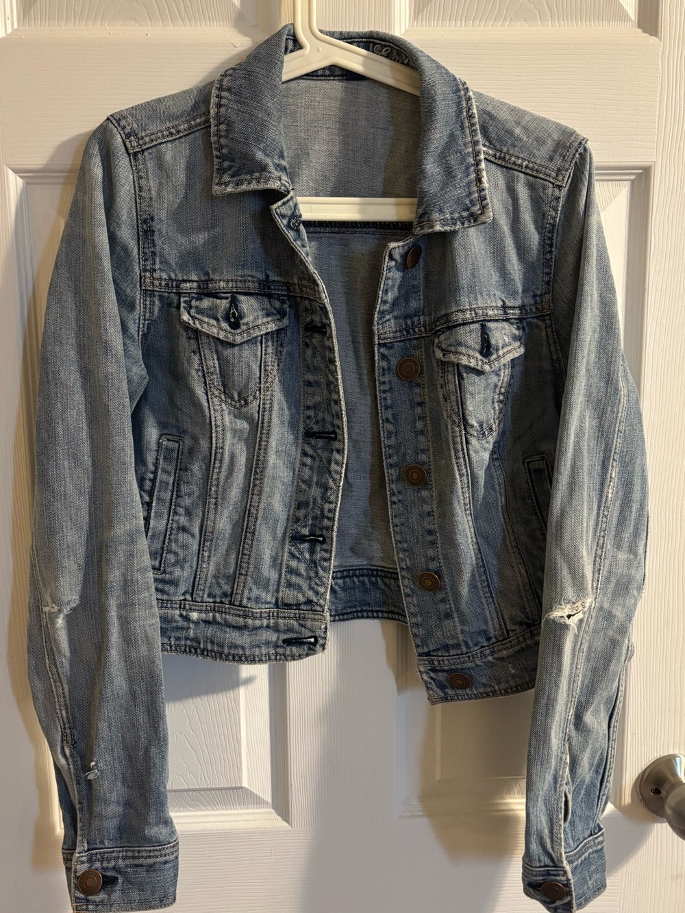 Light wash distressed cropped denim jacket